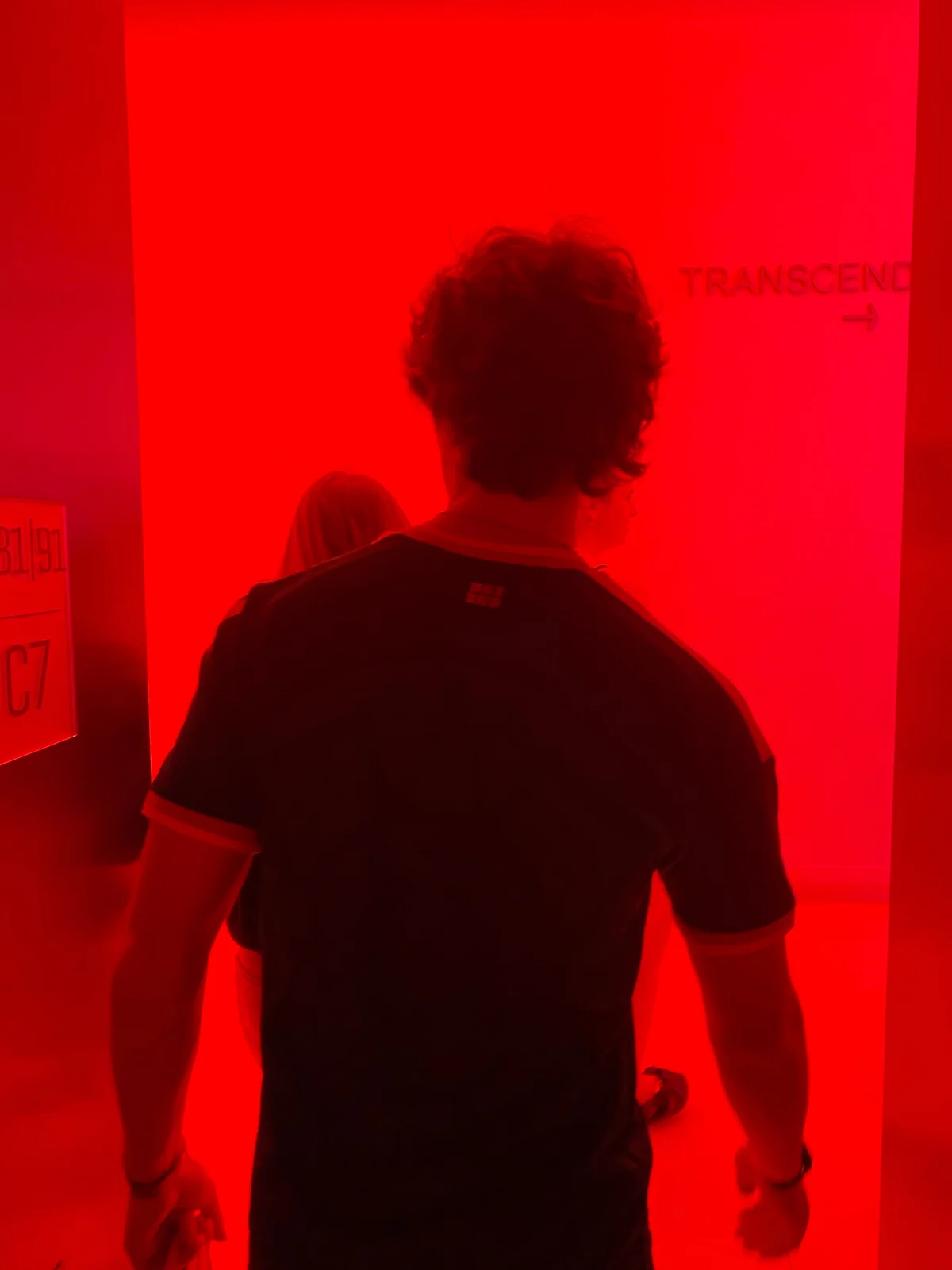 Max Ferrer walking through a red-lit Transcend installation